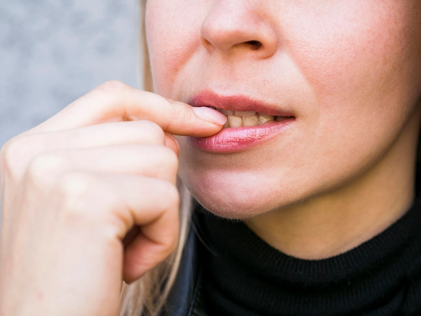 front view nail biting bad habit concept