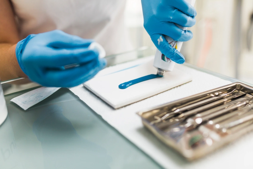 male dentist using blue silicone impression material