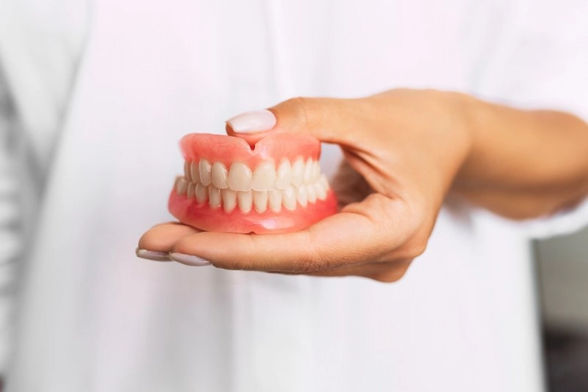 how does powder denture adhesive work