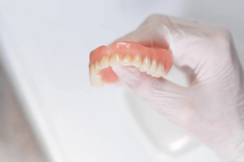 is your tooth loose dont use denture adhesive!