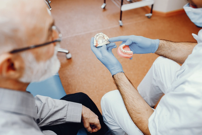dentist explaining dental implants to senior patient