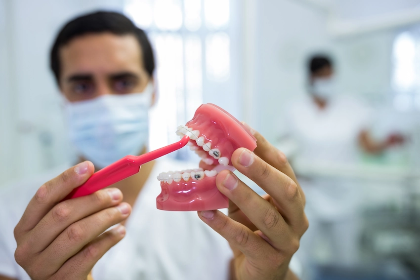 dentist demonstrating oral care full mouth dental implant lema dental clinic